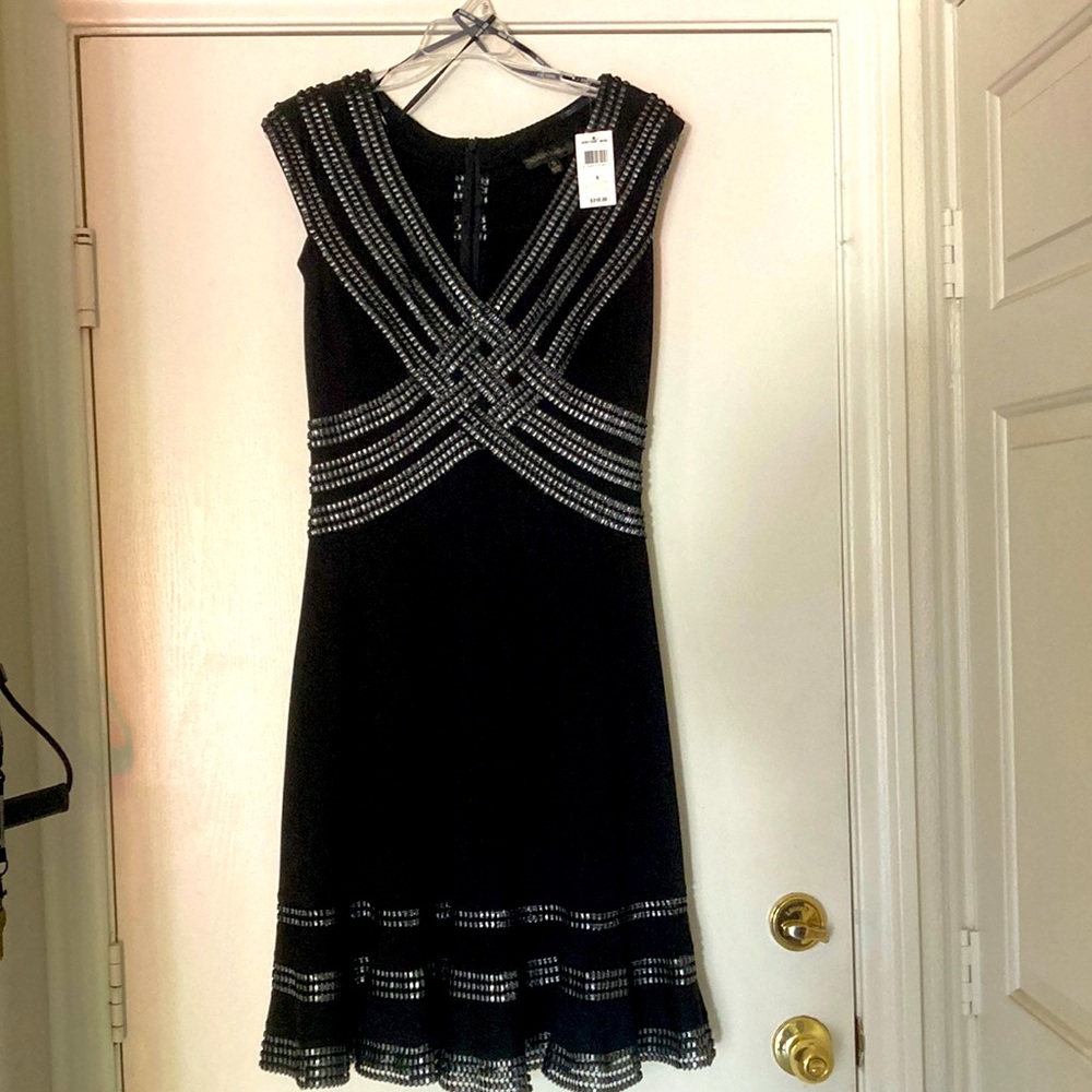 Tadashi Shoji dress. Never warn. Size small. In black. Stretchy fabric